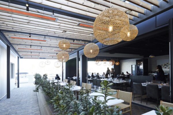 Fixtures installed to top of pergola for indoor/outdoor patio at a restaurant