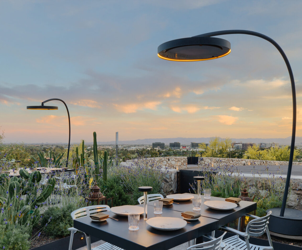 Infrared eclipse pole mounted fixtures above table in desert.